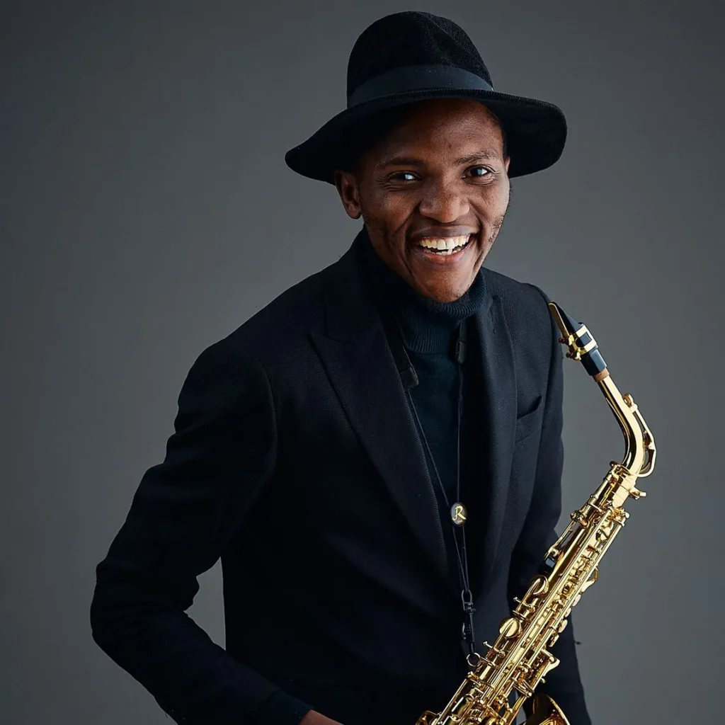 Portrait of Jose Sax holding a gold alto saxophone