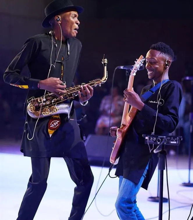 Jose Sax on stage with a guitarist