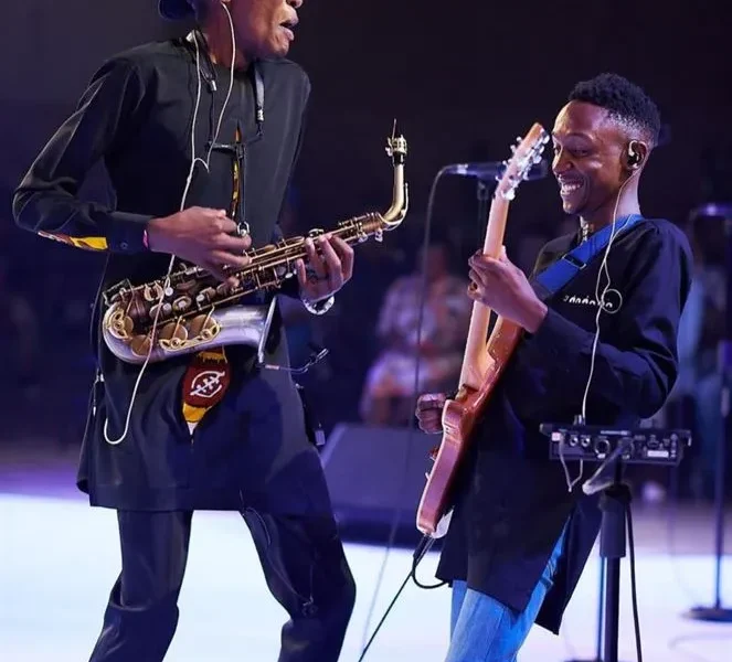 Jose Sax on stage with a guitarist